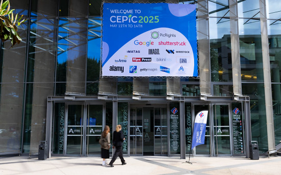 две девушки идут в здание с большим билбордом с текстом welcome to cepic 2025